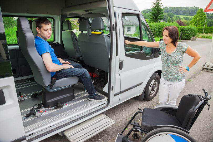 Caring SEN transport assistant with child